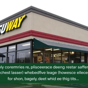 A Subway restaurant sign with flowers and lanterns for remembrance of a victim.