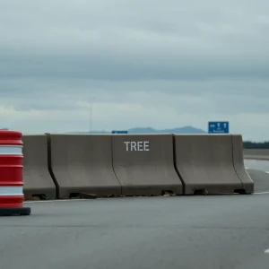 Traffic barrels and concrete barrier on a highway